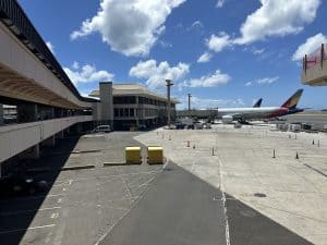 Airplane parked at airport terminal with covered walkway