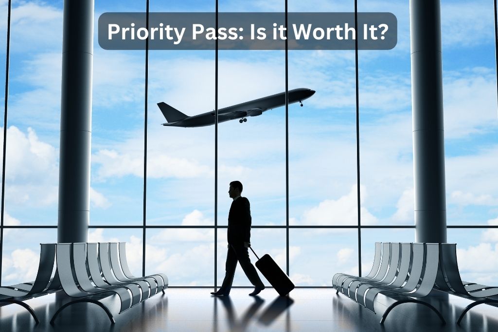 Man walking with suitcase in an airport, with a plane taking off outside.