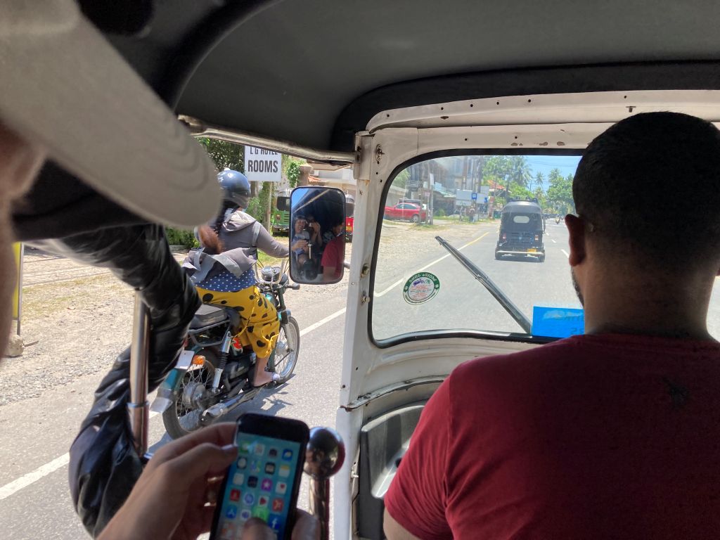 View from inside a 3-wheeled tuk-tuk vehicle in Sri Lanka.