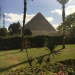 The Great Pyramid with a grass lawn in the foreground.