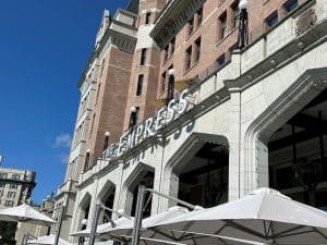The outside of a Victoria Hotel. The sign over the doorways reads "The Empress."
