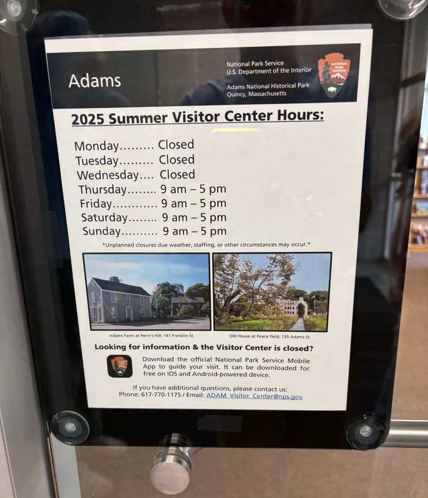 Sign showing 2025 summer visitor center hours for Adams National Historical Park in Quincy, Massachusetts, with days of the week listed and photos of historic sites below.