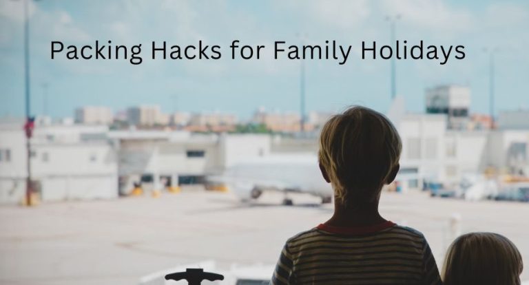 Two children looking out an airport window at an airplane taking off, with overlay text “Packing Hacks for Family Holidays.”