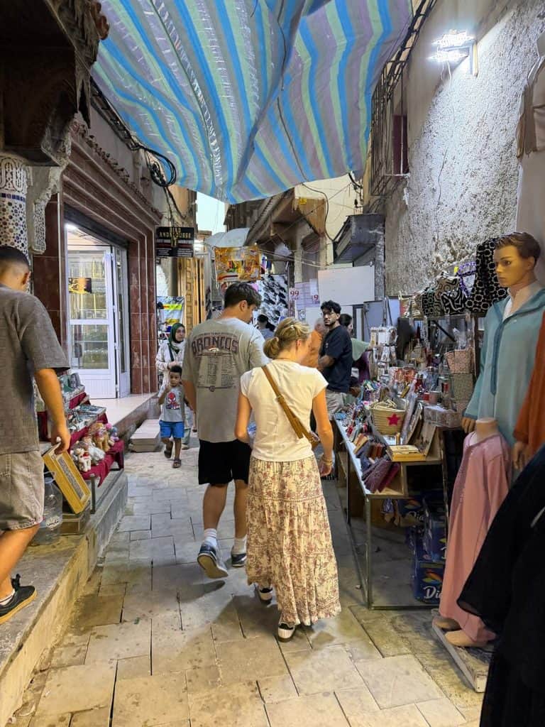 Narrow shopping lane inside the medina in Meknes, Morocco.