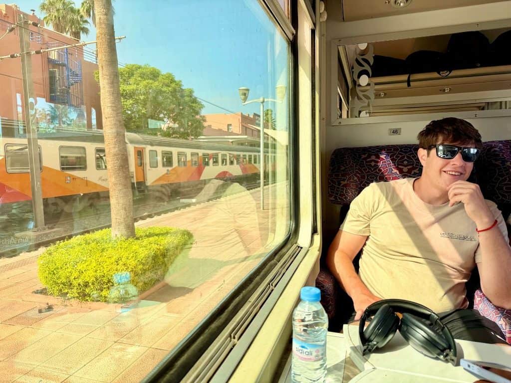 Passenger sitting beside the window inside a first-class train in Morocco.