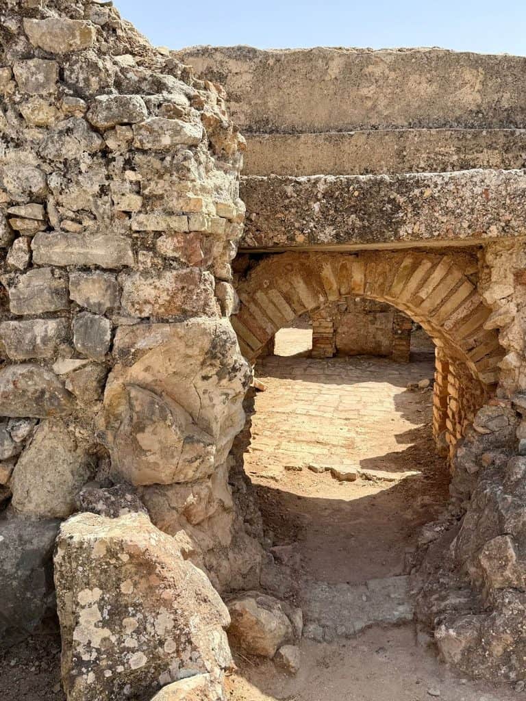 Stone arches and remains of Roman bath structures at Volubilis in Morocco.