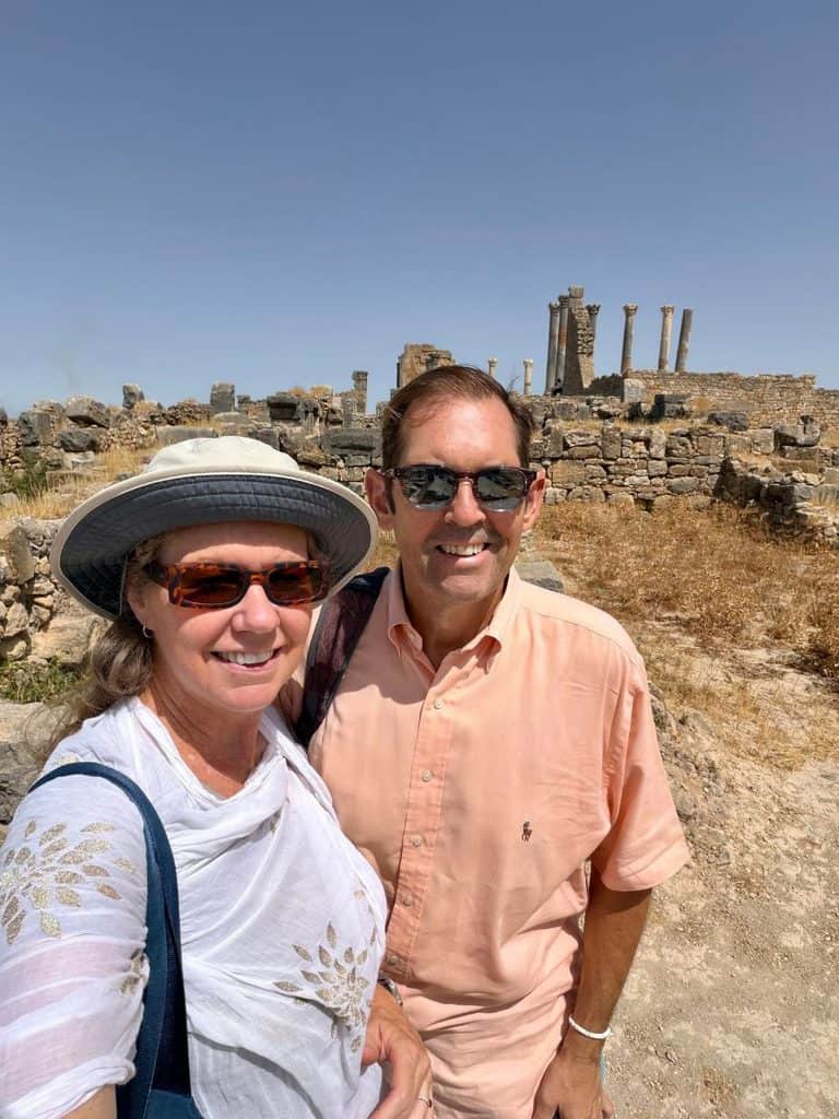 Couple visiting the ancient Roman ruins of Volubilis near Meknes, Morocco.